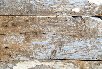 Weathered wooden surface with peeling paint showcasing age and character
