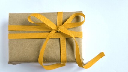 golden gift box, Gift box with kraft paper and yellow ribbon and bow, minimalism and macro, gift...