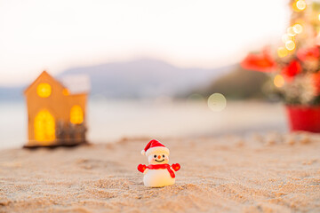 Santa Claus Doll Cute and Christmas Tree House Relaxing on the Beach. Merry Christmas Holiday. Bright Background. Patong Beach, Phuket, Thailand.
