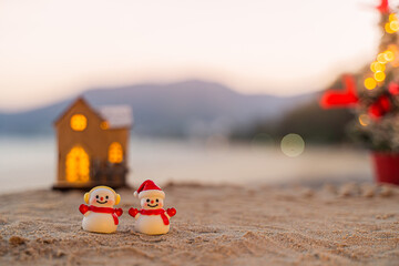Santa Claus Doll Cute and Christmas Tree House Relaxing on the Beach. Merry Christmas Holiday. Bright Background. Patong Beach, Phuket, Thailand.