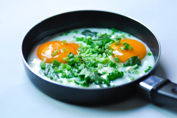 fried egg or sunny side up egg with vegetable topping before fry
