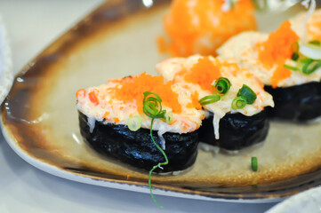 maki , Japanese roll or rice roll or seaweed roll with shrimp egg topping