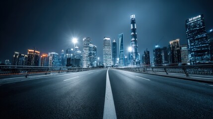 Naklejka premium Night Cityscape View with Empty Road Leading to Illuminated Skyscrapers in Business District