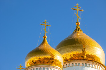 Beauty golden dome of Orthodox Church with cross against blue sky. Concept Christian temple banner...