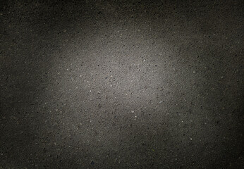 Fototapeta premium background texture of dark asphalt with a light spot in the middle