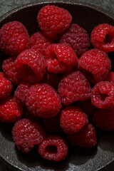 raspberries in a black dish
