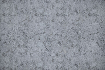 Rough and stained gray concrete wall with a subtle, mottled pattern, creating a seamless and urban-style background
