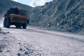 sprinkler pours water on the road in the quarry, so that there i