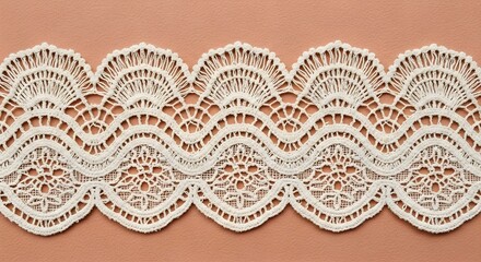 White decorative lace trim on peach background.