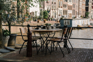 table and chairs in a cafe at a canal, Amsterdam	
