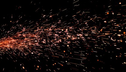 A dynamic spray of glowing orange sparks from industrial grinding, creating an abstract fiery trail on a black background.