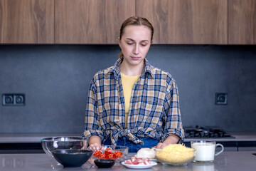 Woman Slicing Ingredients for Quiche in the kitchen.