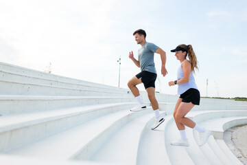 Energetic morning workout session at a scenic outdoor staircase with enthusiastic runners enjoying fitness together