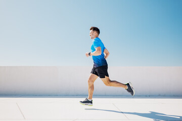 Dynamic runner enjoying a vibrant sprint on a sunny rooftop overlooking the cityscape in a moment...
