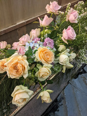 Close-up of an artificial flower bouquet. This bouquet consists of several types of fake flowers and leaves.