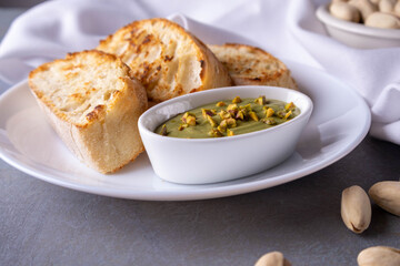 pistachio spread with bread on plate