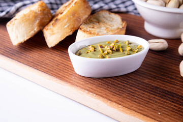 pistachio spread with bread on board
