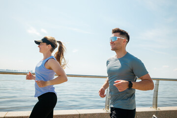Couple enjoying a morning jog along a scenic waterfront pathway with stunning views and energizing...