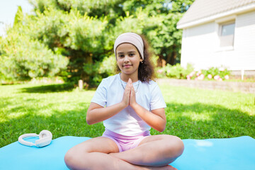 Practicing mindfulness and meditation outdoors with serene focus in a sunny garden