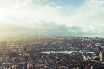 From a high vantage point, the sprawling city of Porto unfolds, its terracotta rooftops reaching...