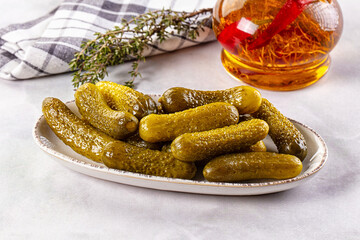 Marinated canned green cornichon cucumbers