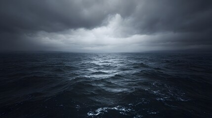 Vast, dark ocean beneath a stormy sky.