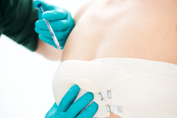 Fototapeta premium Medical aesthetic body contouring injections and examinations