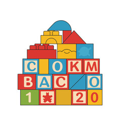 Fototapeta premium Colorful alphabet blocks and building toys stacked in a pyramid shape.