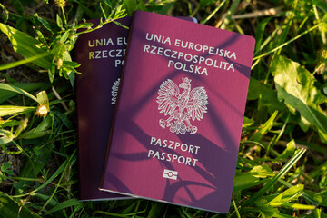 Lost Polish passport concept showing biometric travel document on grass, symbolizing misplaced identity papers, travel disruption, and security risks abroad