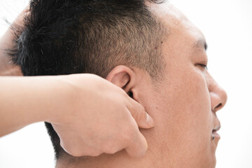Naklejka premium A professional massage therapist gives a head massage to a man.