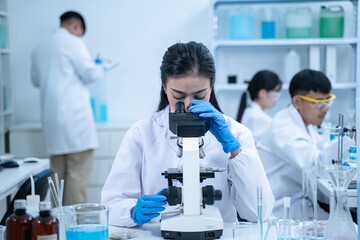 In the laboratory, several researchers and scientists, each focused on their own biology...