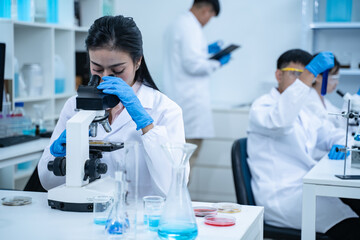 In the laboratory, several researchers and scientists, each focused on their own biology...