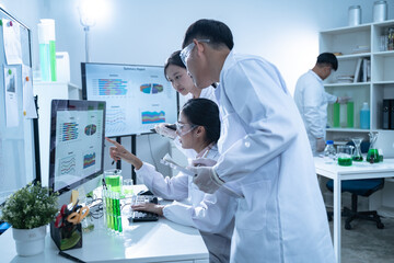 In the laboratory, a biologist uses advanced technology and computer analysis to compare data from...