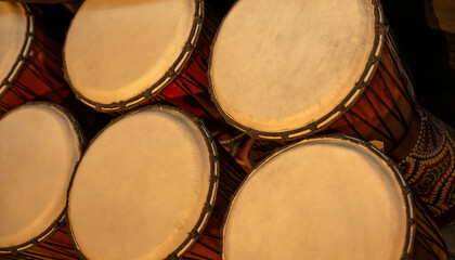 Group of native drums with patterns on the sides create an interesting grouping. Narrow range of...