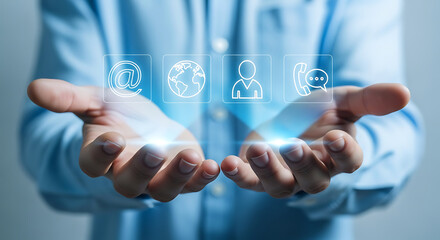 A person's hands hold holographic communication icons, representing digital contact methods.