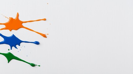 Colorful paint splatters on a white surface.