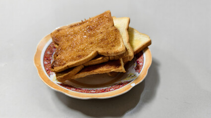 Delicious Crispy Toast on plate isolated on gray background