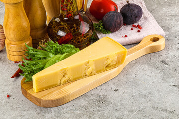 Hard parmesan cheese triangle over board