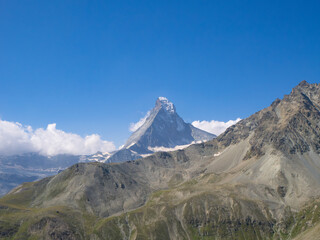 Zermatt, Switzerland - August 24th 2024: Untypical view towards Mattterhorn peak, behind a rocky mountain ridge
