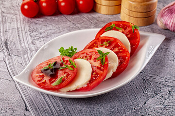 Italian caprese salad with mozzarella, tomato and basil