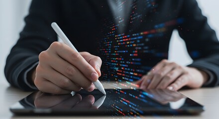 Person using a stylus on a tablet displaying digital code and data