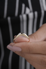 Gold Diamond engagement ring for women and girls lifestyle image with model hand 