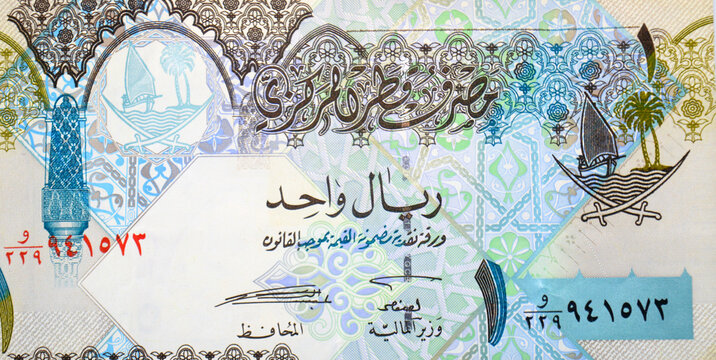 Large fragment of the obverse side of 1 Qatari Riyal cash money currency of Qatar banknote features Ornated column, arches, sailboats, palm trees, crossed swords, vintage retro old leftover Qatar bill