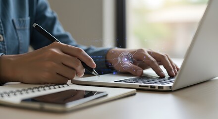 Person working on laptop with digital interface and pen, business and technology concept