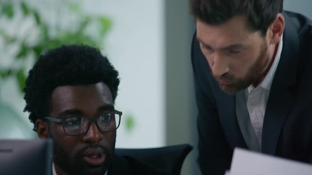 Diverse business team problem meeting in office arguing talking irritated multiracial partners three co-workers trouble documents computer work digital tablet data misunderstanding job mistake argue