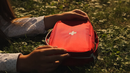 First aid kit. First aid kit and grass. Green grass. High quality photo.