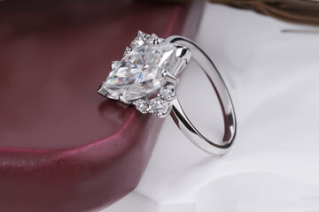 Silver Diamond Engagement Ring for women isolated on wooden podium 