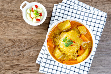 thai yellow chicken curry and roti in the white bowl