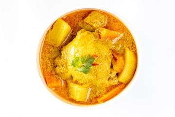 thai yellow chicken curry and roti in the white bowl