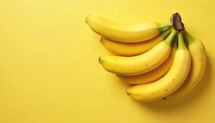 Bunch of ripe yellow bananas on a bright yellow background. Minimalist design with copy space for text. Healthy, organic fruit, perfect for summer promotions, diet, or vegan concepts.